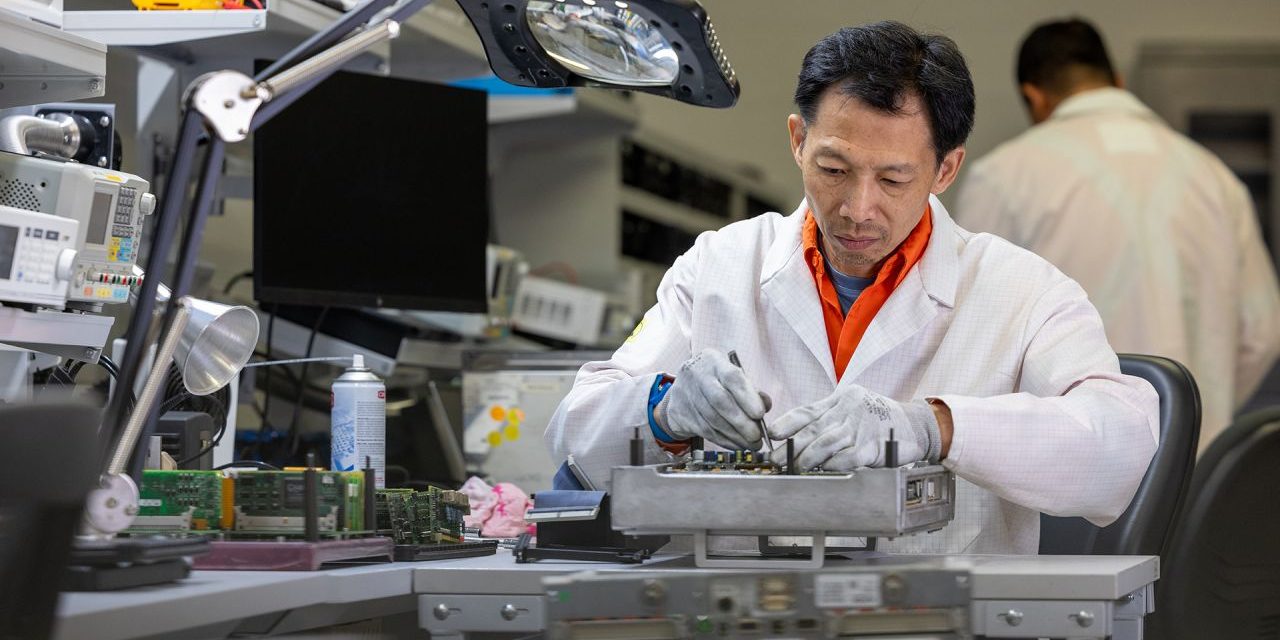 Alstom repair technician repairing a fault circuit board in an in house repair lab
