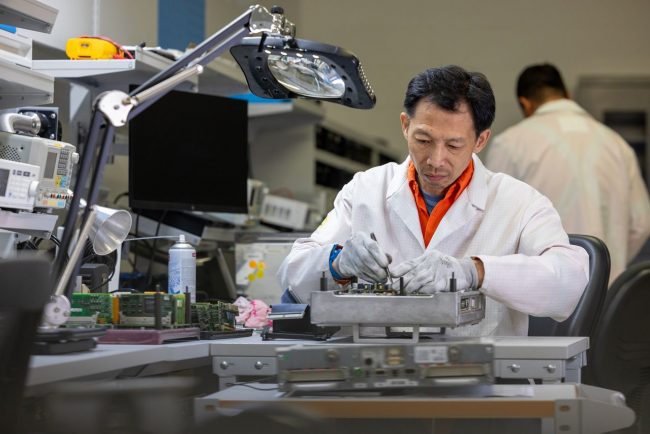 Alstom repair technician repairing a fault circuit board in an in house repair lab