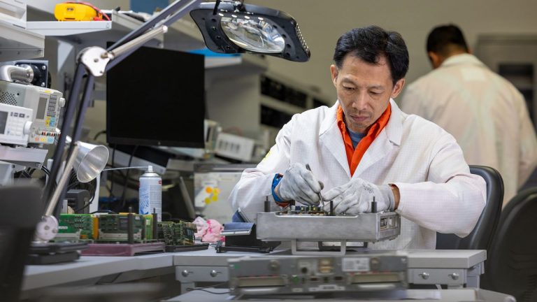 Alstom repair technician repairing a fault circuit board in an in house repair lab
